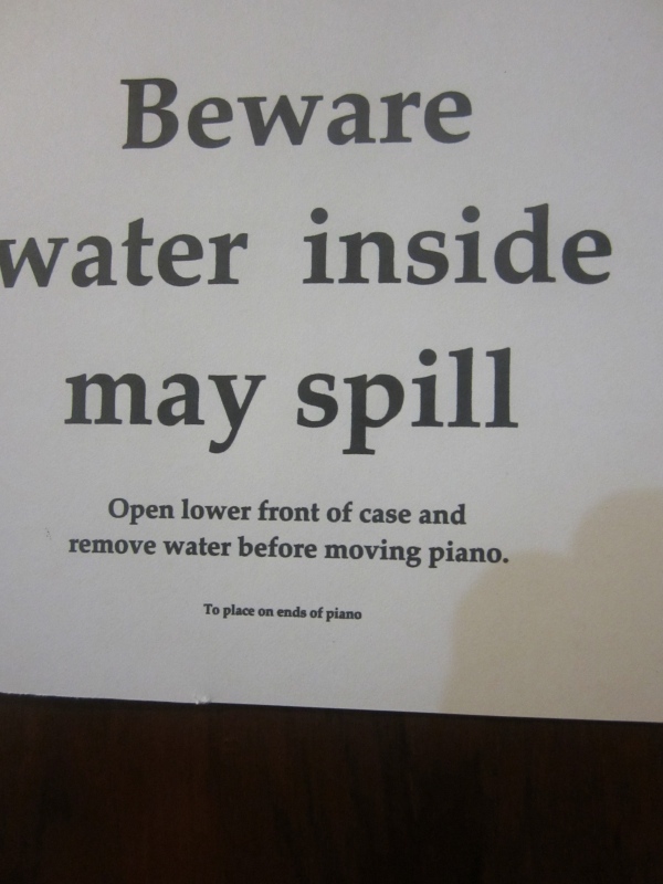20130123.05-water-inside-piano-may-spill-sign72.jpg